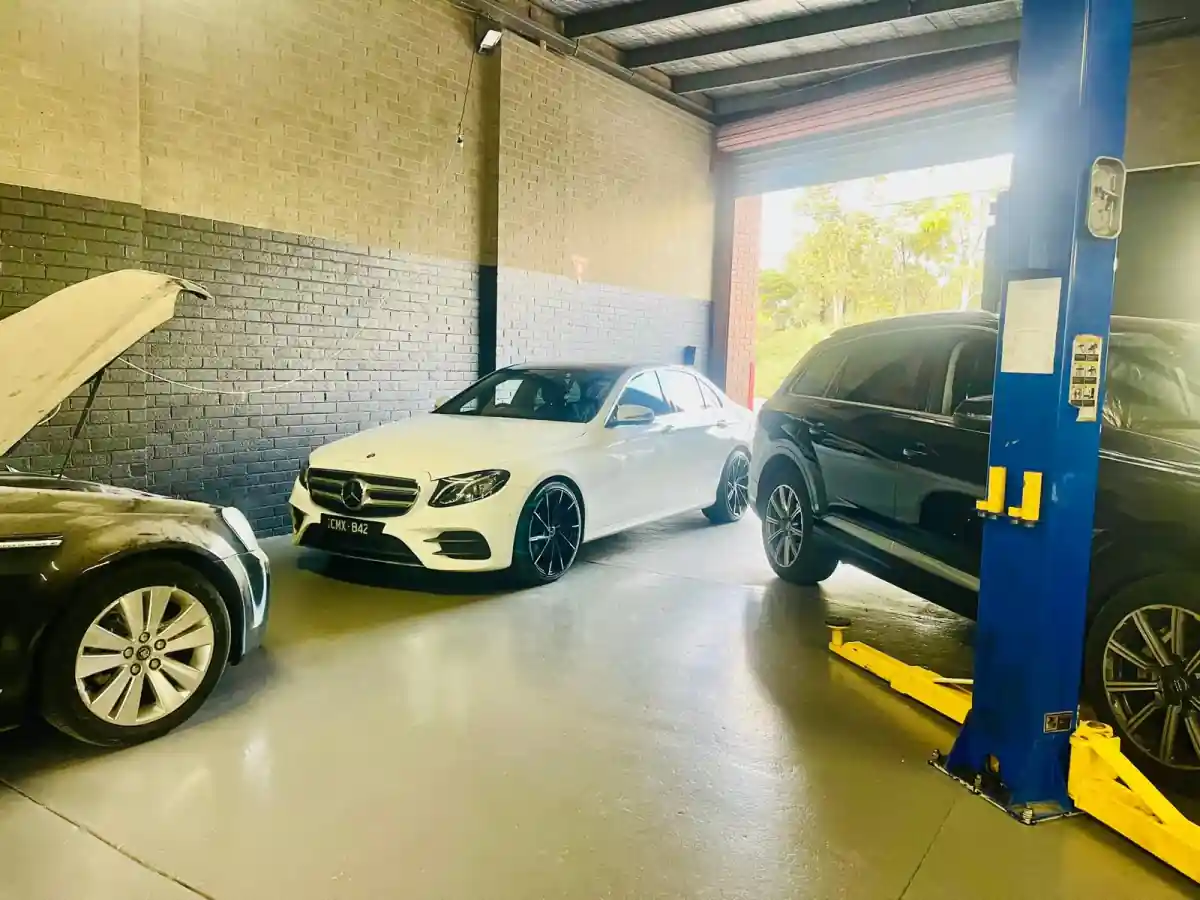 Mercedes-Benz E-Class and Audi SUV parked inside the AutoworkX workshop