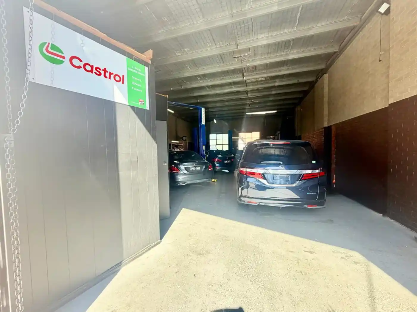 Castrol official partner banner at the entrance to the AutoworkX workshop